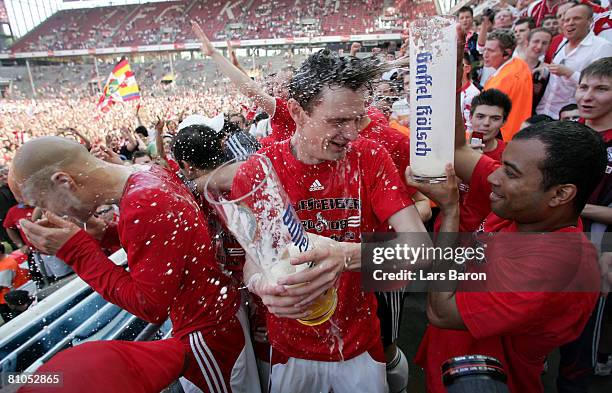 Milivoje Novakovic of Koeln gets a bear shower after winning the Second Bundesliga match between 1. FC Koeln and FSV Mainz 05 at the RheinEnergie...