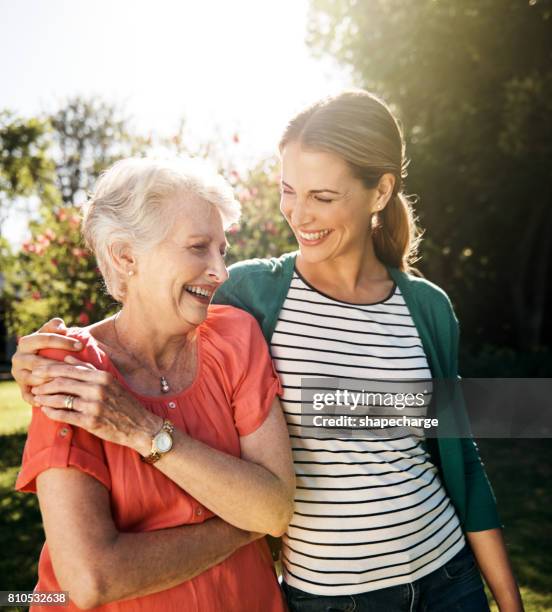 that mother daughter bond...the gift that keeps on giving - old woman young woman stock pictures, royalty-free photos & images