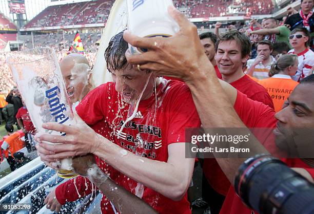 Milivoje Novakovic of Koeln gets a bear shower after winning the Second Bundesliga match between 1. FC Koeln and FSV Mainz 05 at the RheinEnergie...