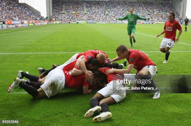Manchester United players celebrate Ryan Giggs scoring their second goal during the Barclays FA Premier League match between Wigan Athletic and...
