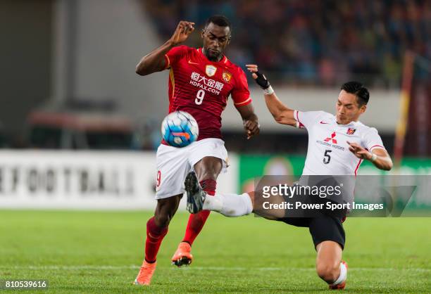 Guangzhou Evergrande forward Jackson Martinez fights for the ball with Urawa Red Diamonds defender Makino Tomoaki during the AFC Champions League...