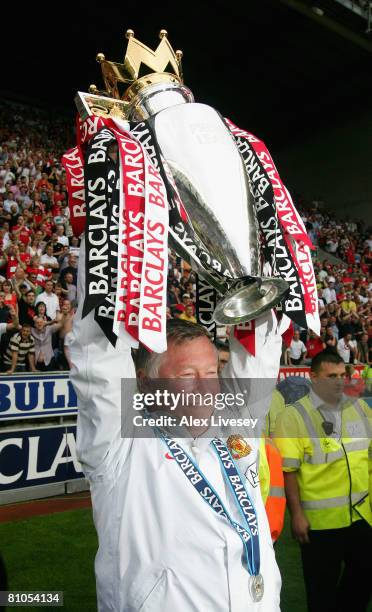 Manchester United Manager Sir Alex Ferguson holds the Barclays Premier League trophy aloft at the end of the Barclays Premier League match between...