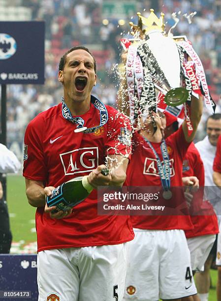 Rio Ferdinand of Manchester United celebrates with champagne after his team won the Barclays Premier League, at the end of the Barclays Premier...