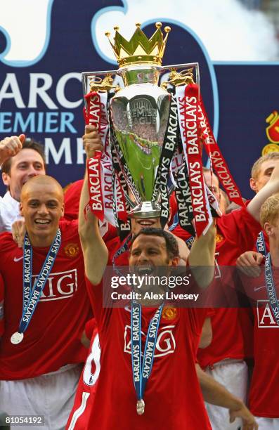 Ryan Giggs of Manchester United lifts the Barclays Premier League trophy following his team's victory at the end of the Barclays Premier League match...