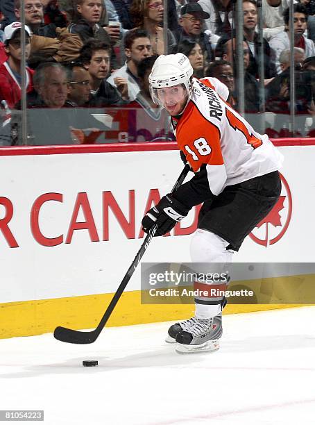 Mike Richards of the Philadelphia Flyers stickhandles the puck against the Montreal Canadiens during game five of the Eastern Conference Semifinals...