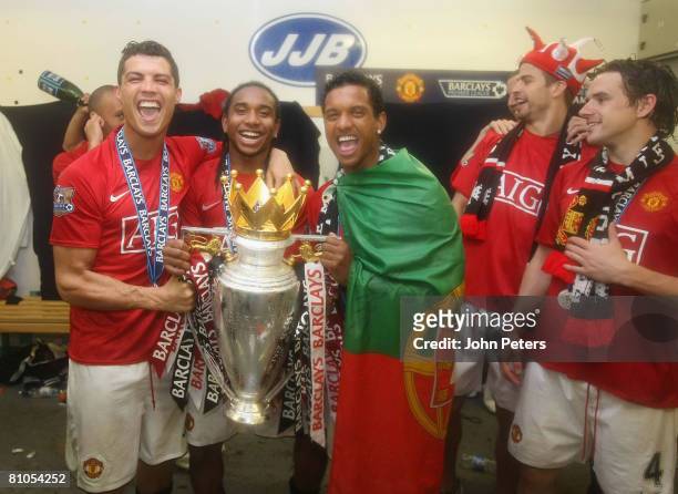 Cristiano Ronaldo, Anderson and Nani of Manchester United celebrate with the Premier League trophy in the dressing room afetr the Barclays FA Premier...
