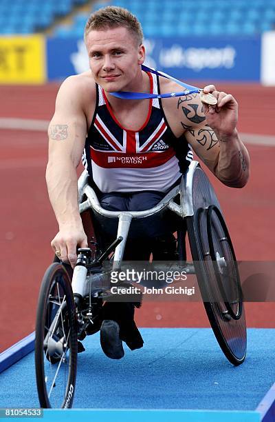 David Weir of Great Britain shows his medal after winning the T54 mens 400 metres during the Paralympic World Cup on May 11, 2008 at Manchester...