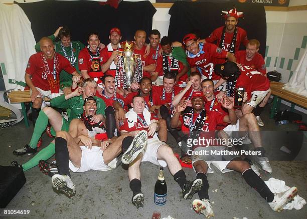 The Manchester United squad celebrate with the Premiership trophy after the Barclays FA Premier League match between Wigan Athletic and Manchester...