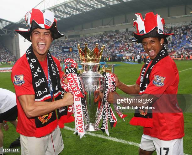 Cristiano Ronaldo and Nani of Manchester United celebrate with the Premier League trophy on the pitch after the Barclays FA Premier League match...