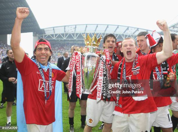Carlos Tevez and Wayne Rooney of Manchester United celebrates with the Premier League trophy on the pitch after the Barclays FA Premier League match...