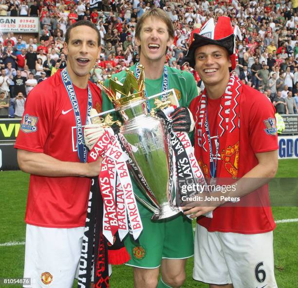 Rio Ferdinand, Edwin van der Sar and Wes Brown of Manchester United celebrates with the Premier League trophy on the pitch after the Barclays FA...