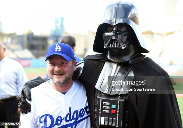 Rian Johnson, director of Star Wars Episode VIII: The Last Jedi, poses with Darth Vader as part of Stars Wars night during a Major League Baseball...
