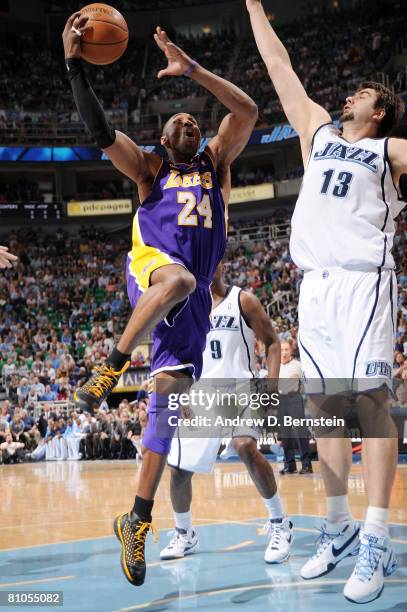 Kobe Bryant of the Los Angeles Lakers gets to the hoop against Mehmet Okur of the Utah Jazz in Game Four of the Western Conference Semifinals during...