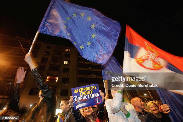 Serbs celebrate in the streets waving an European Union and Serbian flag on May 11, 2008 in central Belgrade, Serbia. Serbs voted in parliamentary...