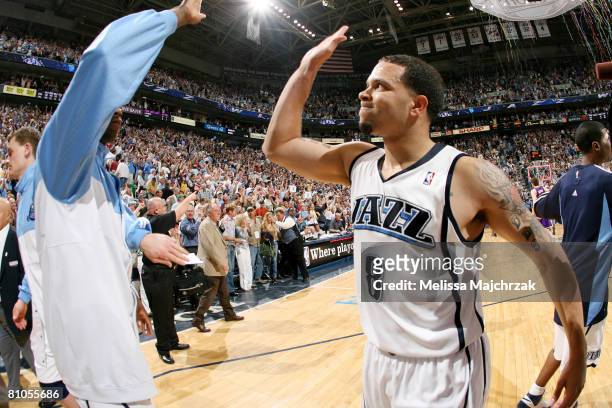 Deron Williams of the Utah Jazz celebrates the win over the Los Angeles Lakers with teammate Ronnie Brewer in Game Four of the Western Conference...