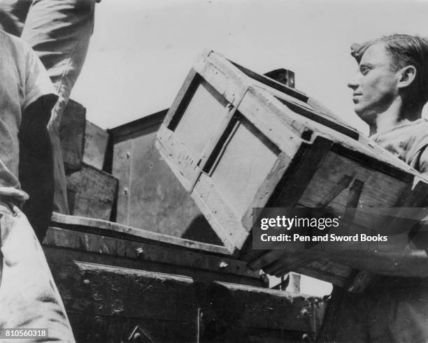 Soldiers Loading Crates onto a Vehicle.