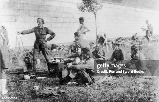 Troops and Members of the Red Cross Service Sat on the Grass.