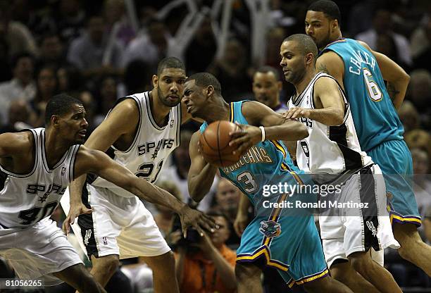 Guard Chris Paul of the New Orleans Hornets is fouled by Kurt Thomas of the San Antonio Spurs in Game Four of the Western Conference Semifinals...