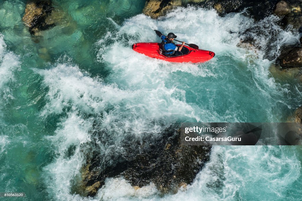 Mature Man Kayaking On River Soca Rapids - High Angle View