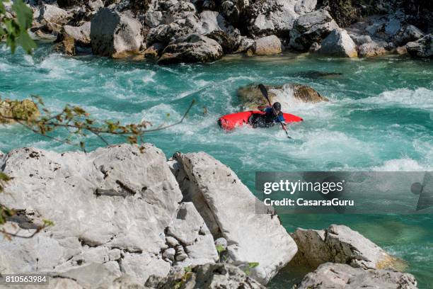 kayaker exploring the white water's of river soca - white water kayaking stock pictures, royalty-free photos & images