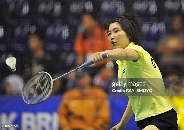 Jiang Yanjiao of China returns a shot against Carola Bott of Germany during their Thomas Cup badminton match in Jakarta on May 12, 2008. Jiang won...