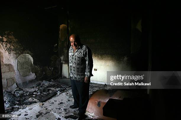 Lebanese man inspects the damage to his living room following fierce gun battles, May 12, 2008 in the town of Shwayfat in the mountains southeast of...