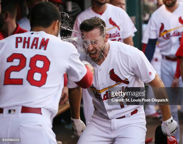 The St. Louis Cardinals' Paul DeJong is doused by teammate Tommy Pham in the dugout after he hit a solo home run in the third inning against the New...