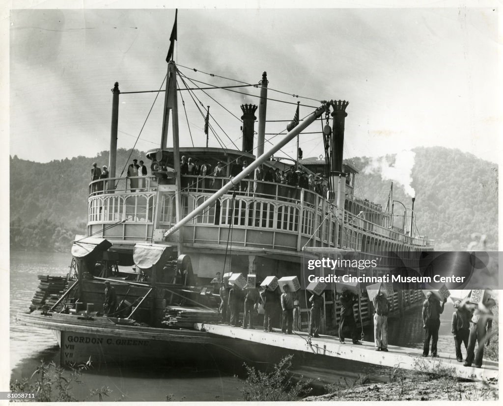 Steamboat Loading Ramp Passengers and crew stand at the railing of the 'cabin deck' of the ...
