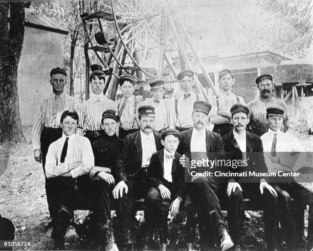 Portrait of a Coney Island Park work crew as they pose before a Ferris wheel-like amusement park ride, Cincinnati, Ohio, late 19th century. George...