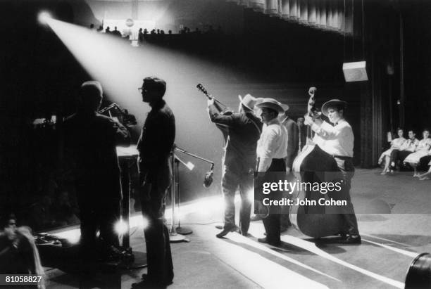 American bluegrass musician Earl Scruggs and his band play onstage at Ryman Auditorium during a performan on the Grand Ol Opry, Nashville, Tennessee,...