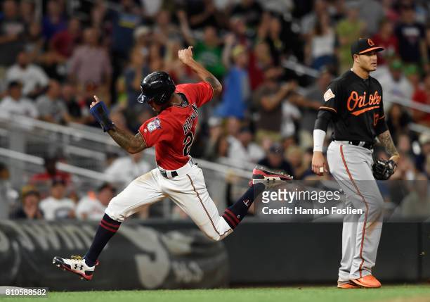 Manny Machado of the Baltimore Orioles looks on as Byron Buxton of the Minnesota Twins rounds third base on his way to score a run during the eighth...