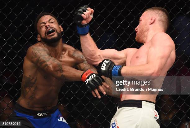Justin Gaethje punches Michael Johnson in their lightweight bout during The Ultimate Fighter Finale at T-Mobile Arena on July 7, 2017 in Las Vegas,...