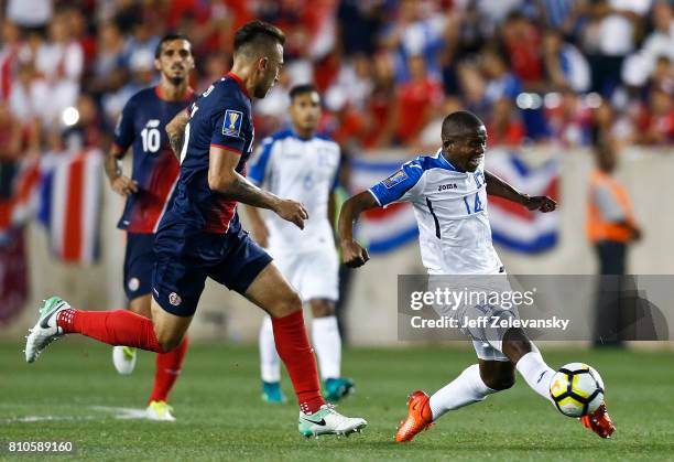 Oscar Boniek Garcia of Honduras drives by Francisco Calvo of Costa Rica during their CONCACAF Gold Cup match at Red Bull Arena on July 7, 2017 in...