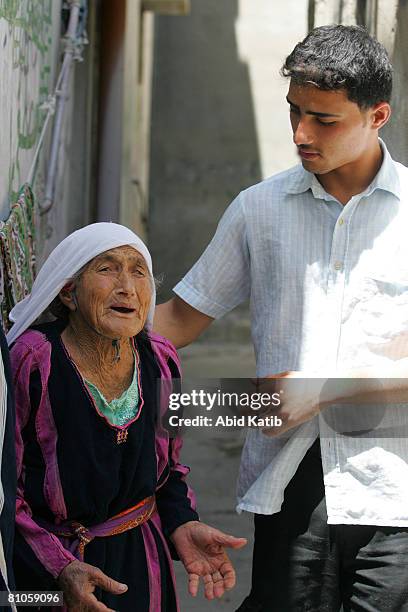 Al-SHATI REFUGEE CAMP-GAZA CITY, GAZA STRIP A hundred and one year old Palestinian refugee Rahma Ali Abed stands next to her grandchild Mohammad in...