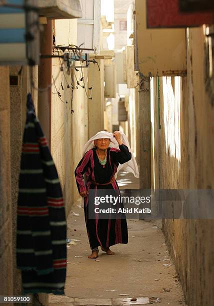 Al-SHATI REFUGEE CAMP-GAZA CITY, GAZA STRIP A hundred and one year Old Palestinian refugee Rahma Ali Abed walks down an alleyway near her home in the...
