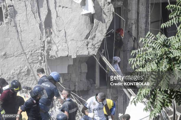 Volunteers and fire fighters work uninterruptedly to try to recover the eight dispersed under the ruins of the collapsed palace at Torre Annunziata,...