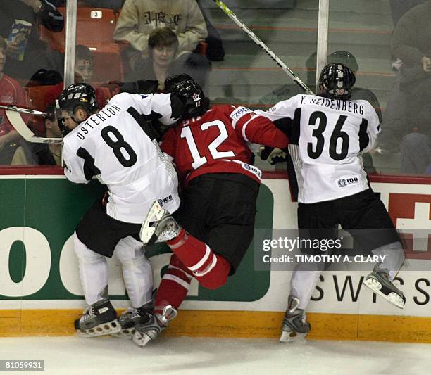 Canada's Eric Staal gets checked by Germany's Sebastian Osterloh and Yannic Seidenberg during the qualification round of the 2008 IIHF World Hockey...