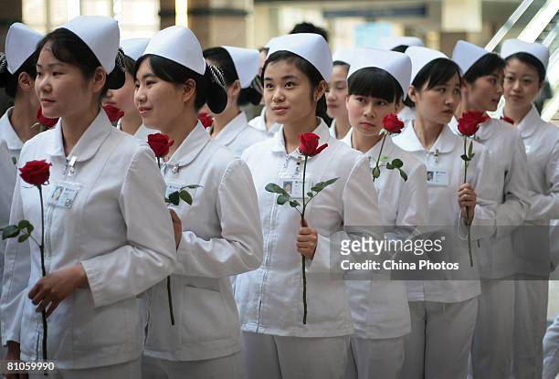 Nurses hold flowers during an event to mark International Nurse Day at a hospital May 12, 2008 in Gaochun County of Jiangsu Province, China. The...