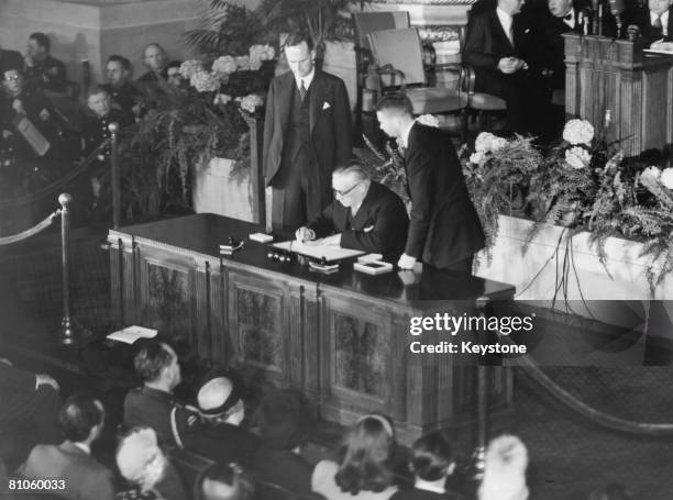 British Foreign Secretary Ernest Bevin signs the North Atlantic Treaty in Washington while Sir Oliver Franks , British Ambassador to the United...