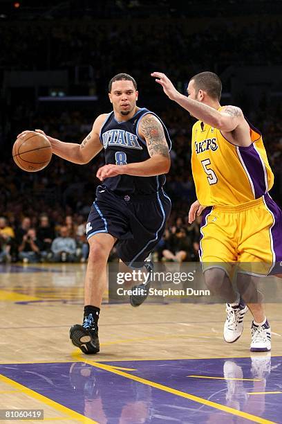 Deron Williams of the Utah Jazz drives to the basket past Jordan Farmar of the Los Angeles Lakers in Game Two of the Western Conference Semifinals...