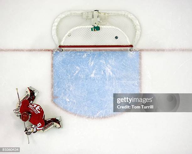 Chris Osgood of the Detroit Red Wings gives up a goal against the Dallas Stars during game two of the Western Conference Finals of the 2008 NHL...