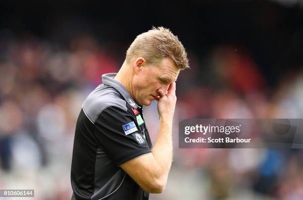 Nathan Buckley, coach of the Magpies reacts as he speaks to his team during a quarter time break during the round 16 AFL match between the...