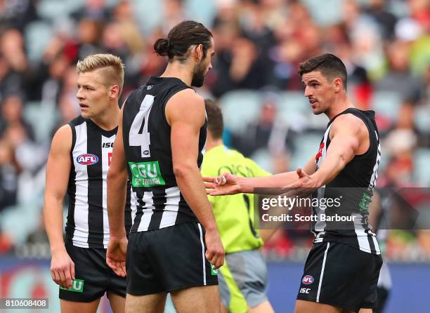 Scott Pendlebury of the Magpies speaks with Brodie Grundy of the Magpies during the round 16 AFL match between the Collingwood Magpies and the...