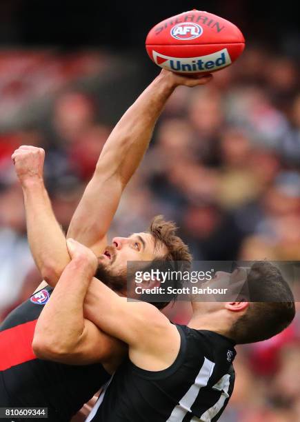 Jobe Watson of the Bombers and Matthew Scharenberg of the Magpies compete for the ball during the round 16 AFL match between the Collingwood Magpies...