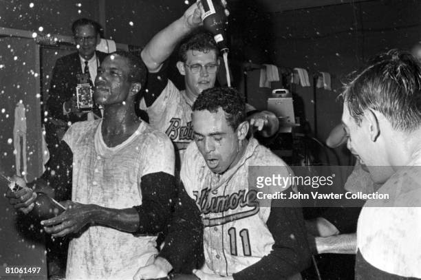 Paul Blair, Gene Brabender, Luis Aparicio and Curt Blefary of the Baltimore Orioles celebrate clinching the American League pennant in the clubhouse...