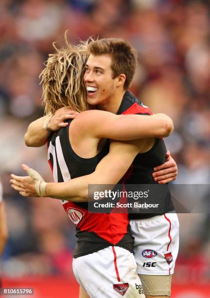 Zach Merrett of the Bombers celebrates after kicking a goal with Dyson Heppell of the Bombers during the round 16 AFL match between the Collingwood...