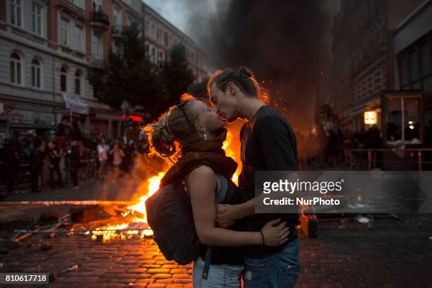 Kissing couple during riots in St. Pauli district during G 20 summit in Hamburg on July 8, 2017 . Authorities are braced for large-scale and...