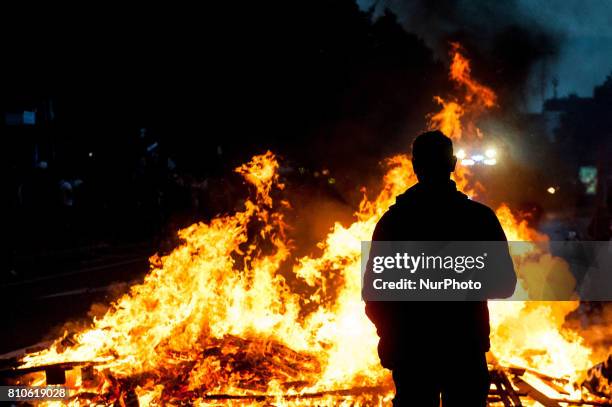 Demonstrator stands in front of a burning barricade, in Hamburg, Germany, on July 7, 2017. In the evening there was a lot of riots in the...