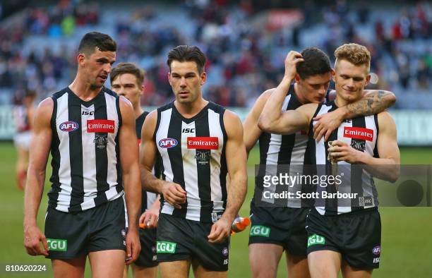 Scott Pendlebury of the Magpies speaks with Levi Greenwood of the Magpies as they leave the field after losing the round 16 AFL match between the...