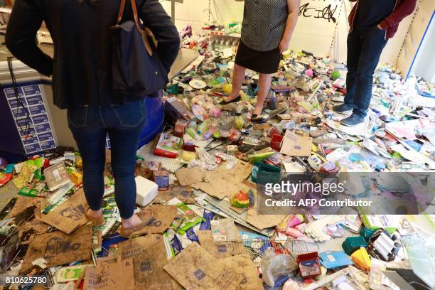 People stand in a looted Budnikowsky drugstore in Hamburg's Schanzenviertel district on July 8, 2017 in Hamburg, northern Germany, where leaders of...